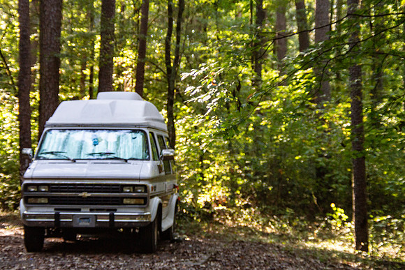 Chevy van camping in the woods