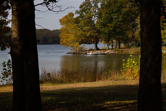 Fishing dock on the shore with autumn scenery