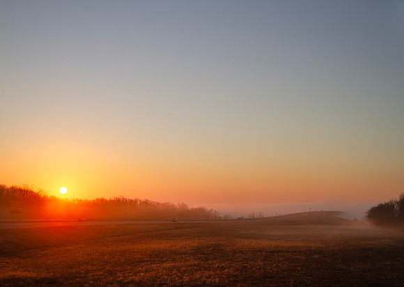 Sunrise in eastern oklahoma, a bridge disappears into the fog