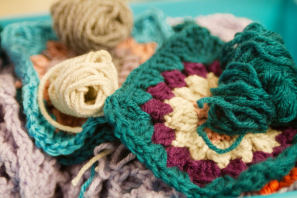 Crochet yarn and hook with balls of yarn and granny square