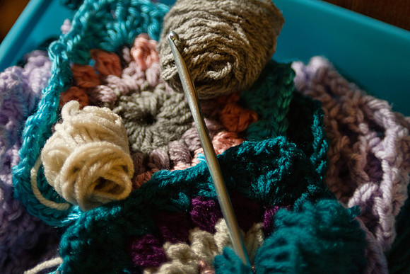 Crochet yarn and hook with balls of yarn and granny square
