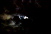 Full moon with colorful clouds, moonlight showing through