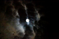 Full moon with clouds in an eerie sky, full Sturgeon Moon