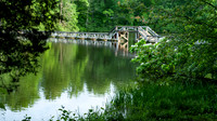 Foot bridge over the lake with reflections