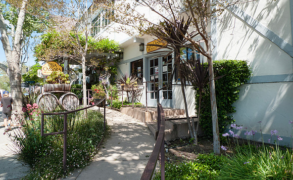 Solvang, California sidewalk with flowers and trellis outside Ca