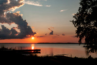 Sunset at on the lake with cloudscape, fishing dock