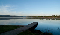Dock on a still lake in springtime at sunrise