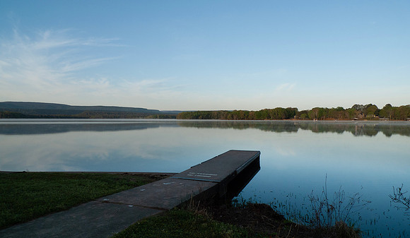 Dock on a still lake in springtime at sunrise