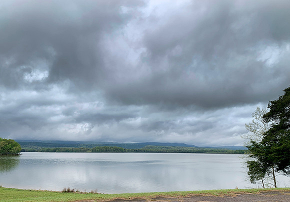 Stormy skies over the lake with distant mountains