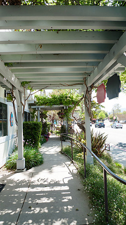 Solvang, California sidewalk with flowers and trellis